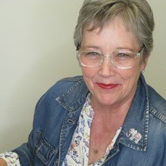 Kim wearing a jean jack with clear glasses